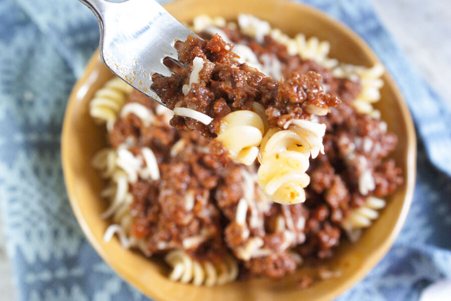 eating beef bolognese with a fork 