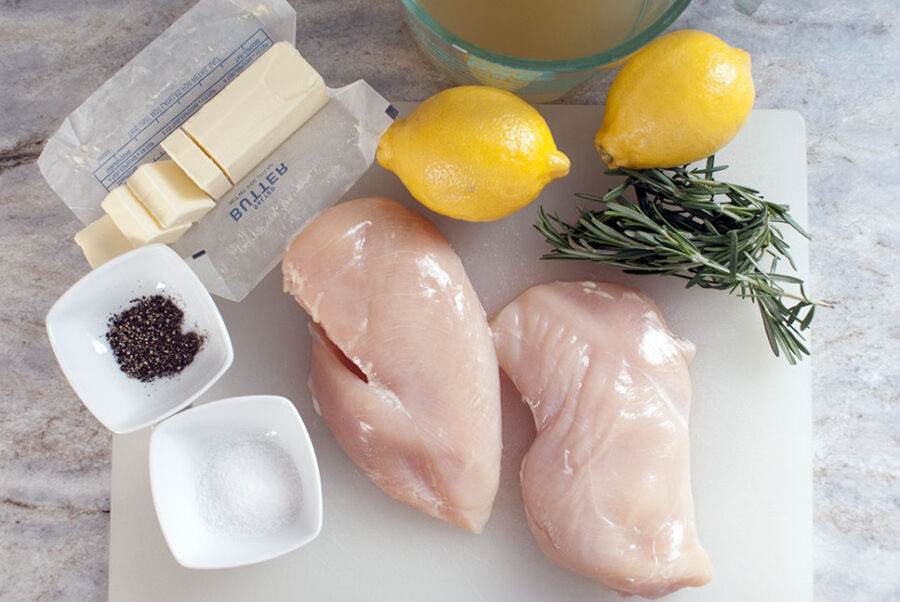 Ingredients for crock pot lemon chicken on a cutting board 