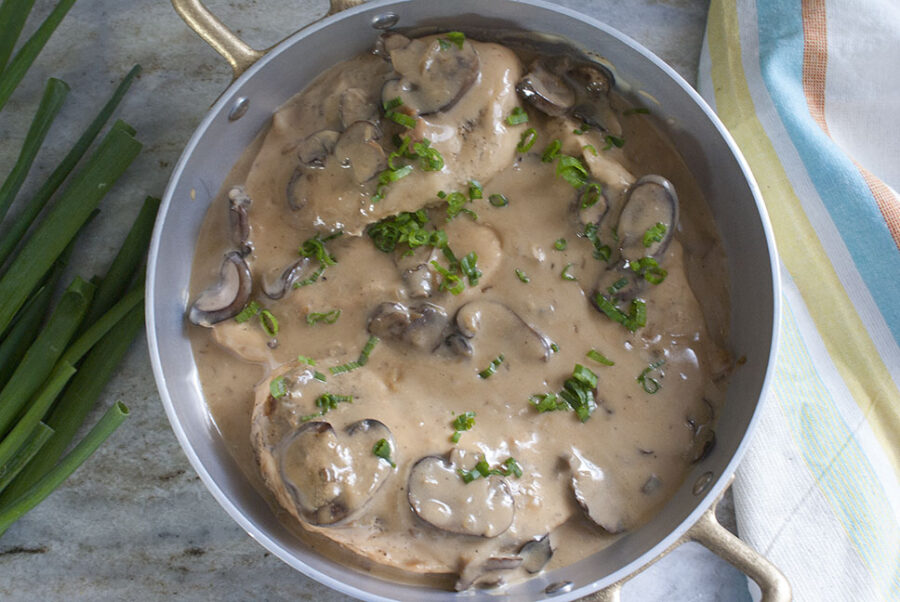 serving dish with smothered chicken and mushroom gravy 